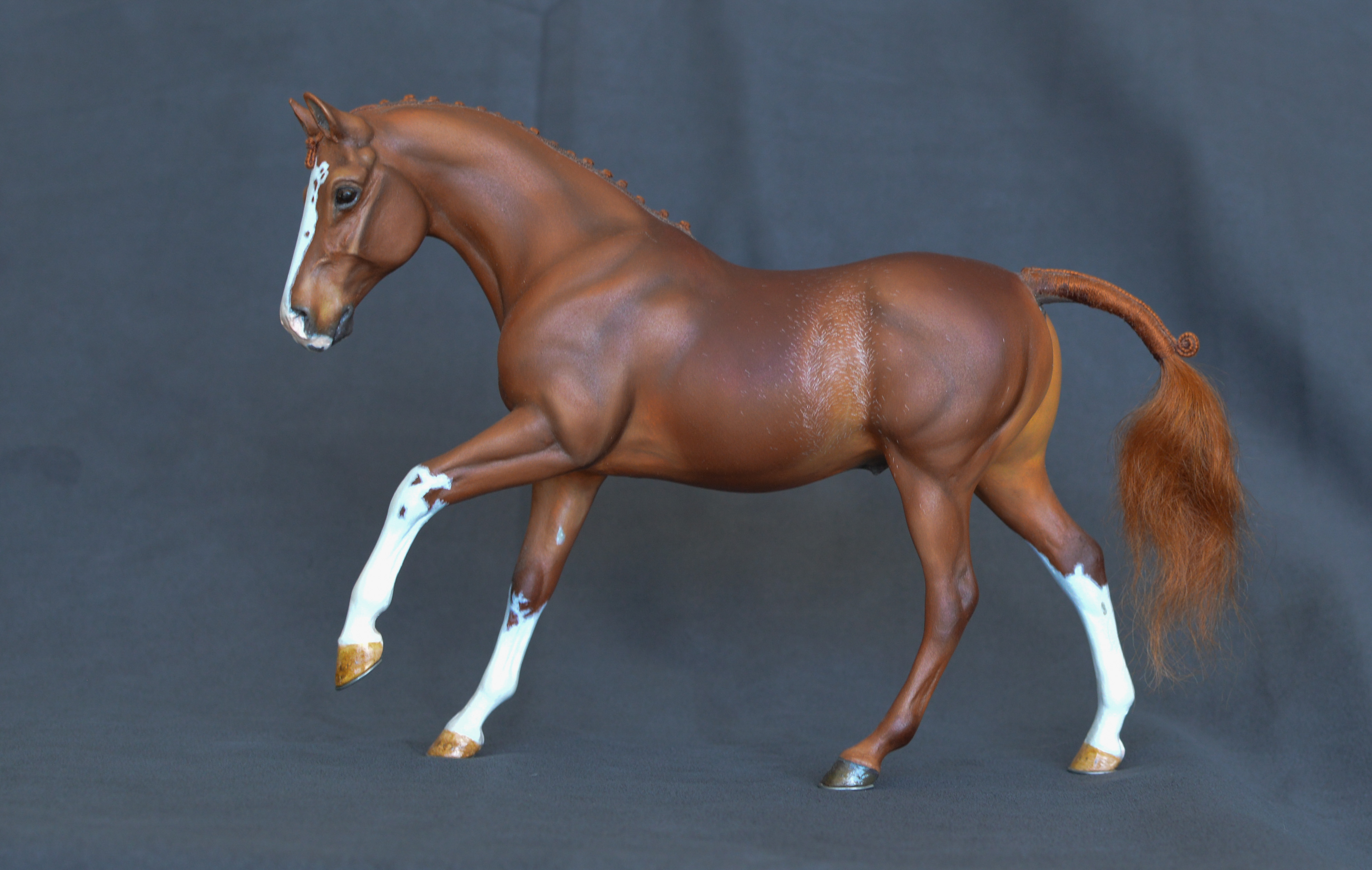 Chestnut model horse, cantering, with high white markings